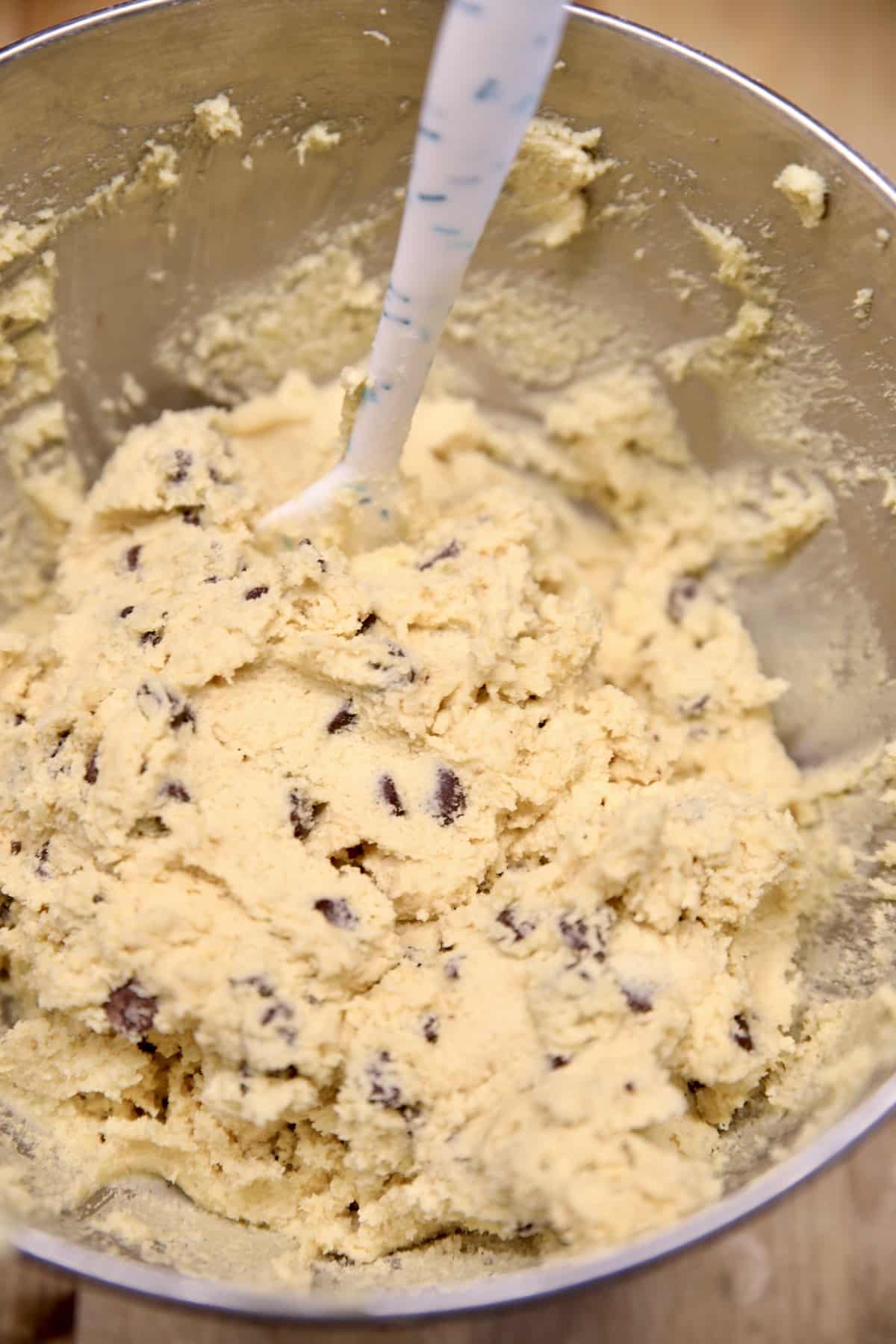 Chocolate chip cookie dough in a bowl.