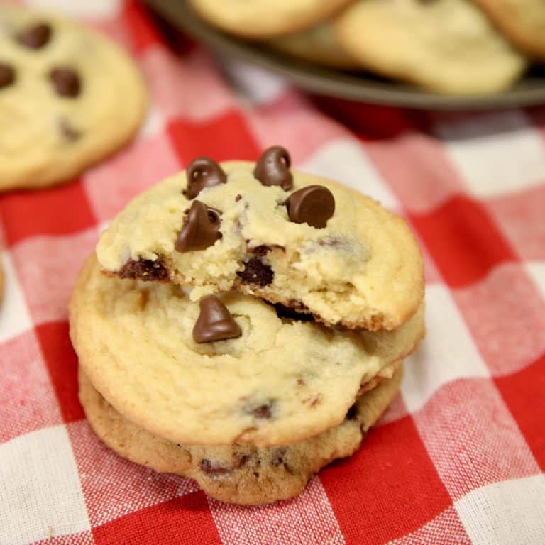Stack of chocolate chip cookies with one in half.
