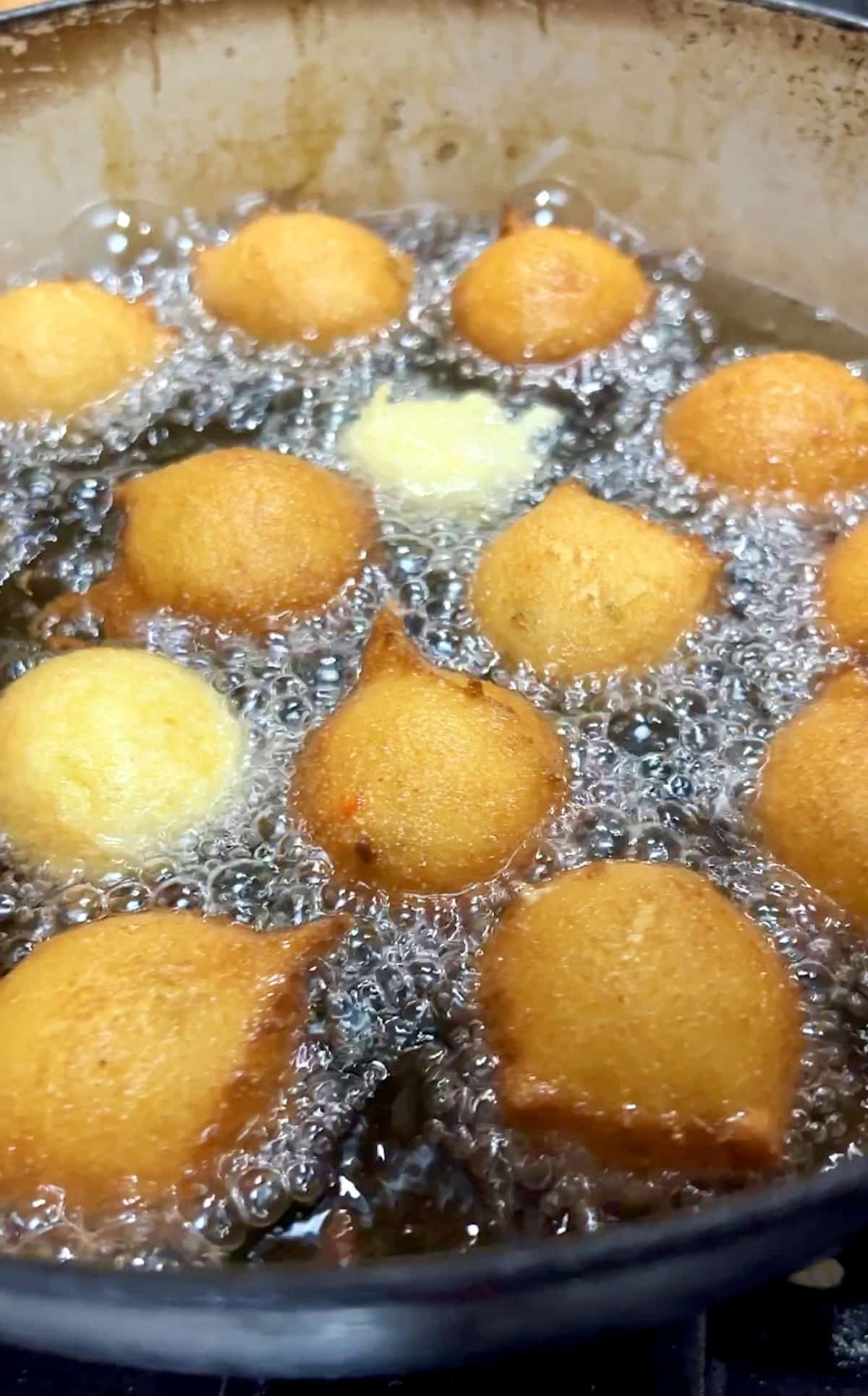 Frying hush puppies in hot oil.