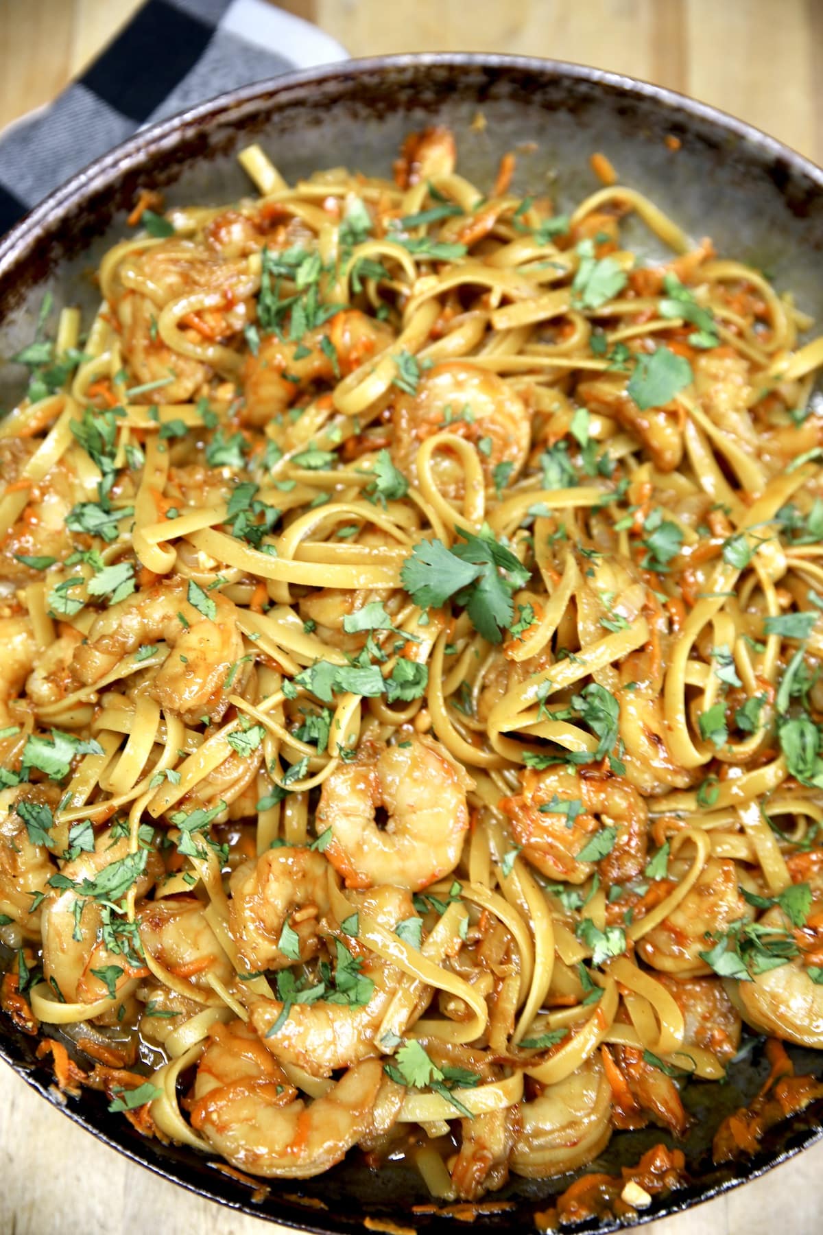 Hoisin shrimp stir fry with noodles in a skillet.