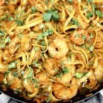 Skillet of Hoisin shrimp stir fry with cilantro garnish.
