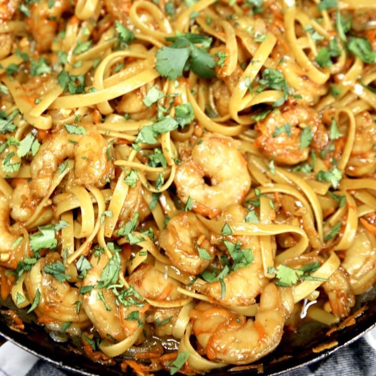 Skillet of Hoisin shrimp stir fry with cilantro garnish.