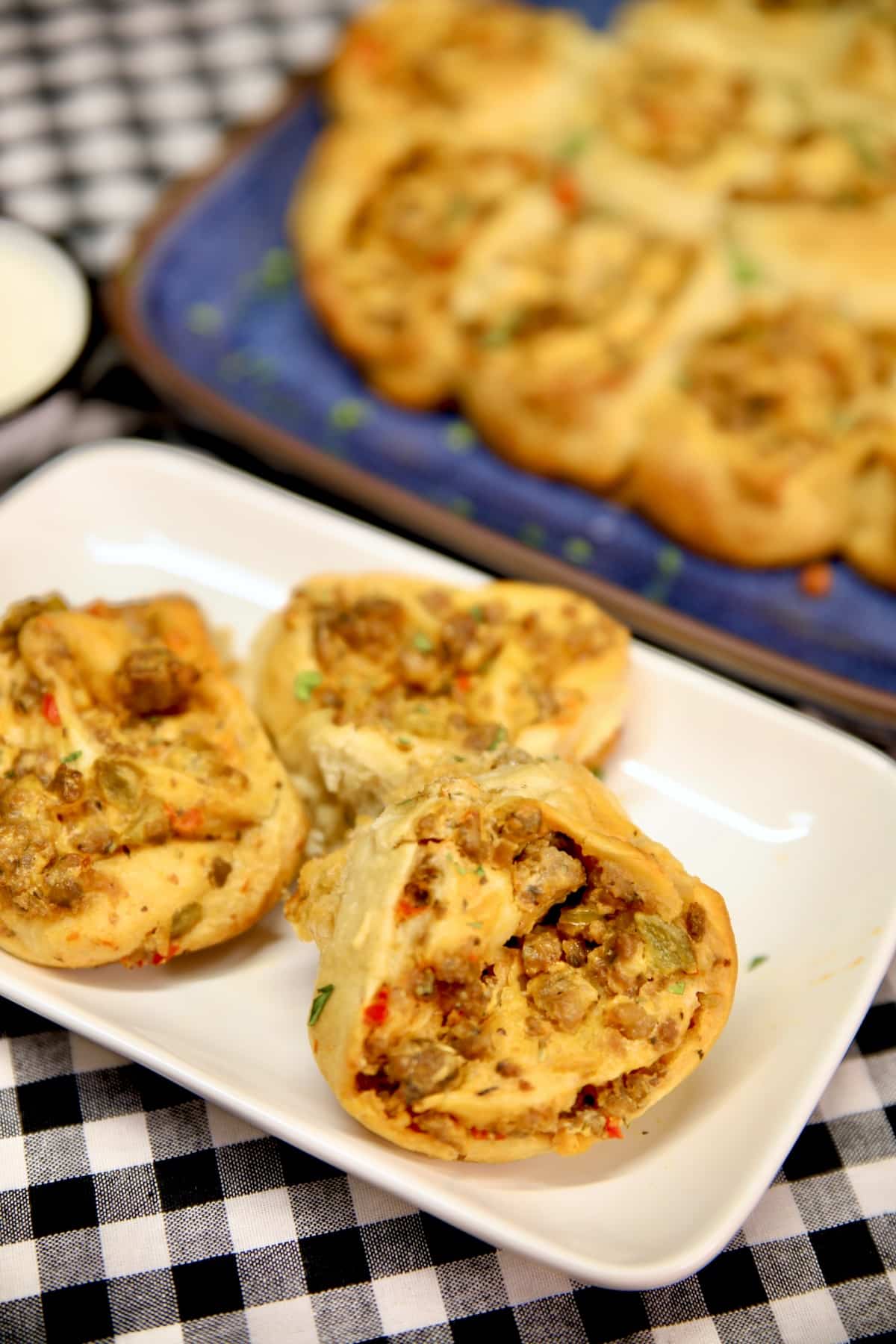 3 sausage pinwheels on a plate.