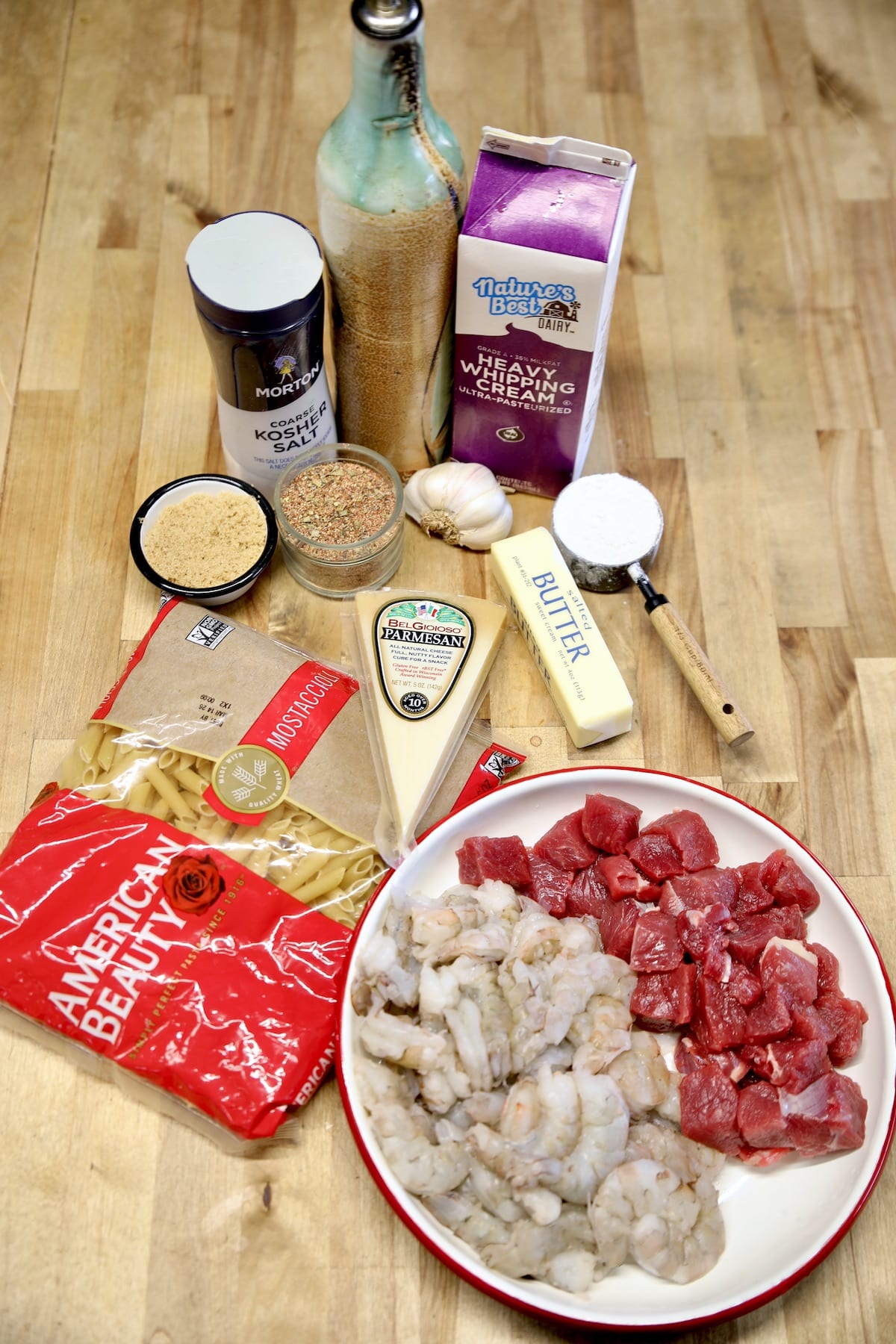 Ingredients for steak and shrimp pasta with Creole seasoning.