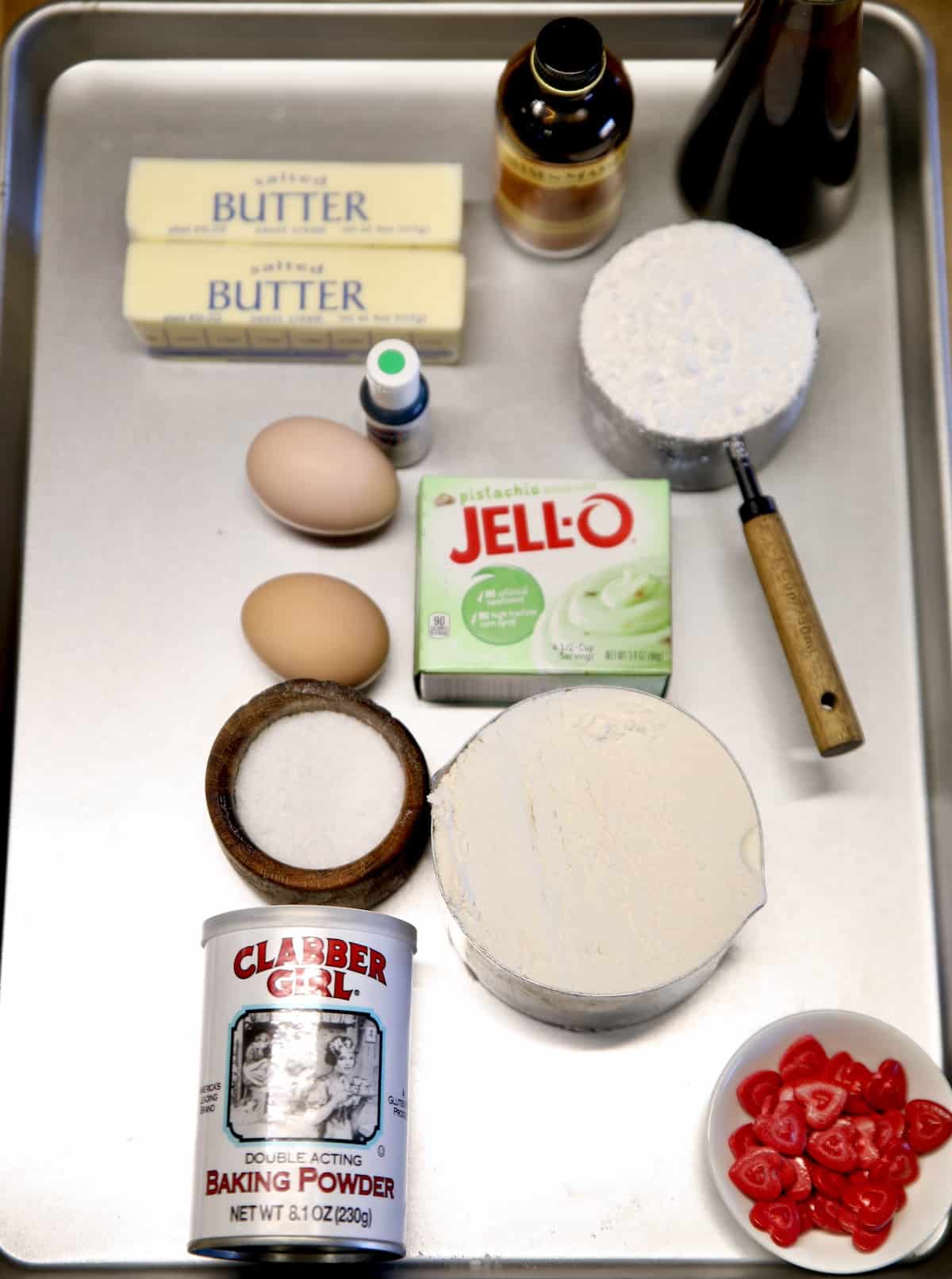 Ingredients for green Grinch Cookies with heart sprinkles.