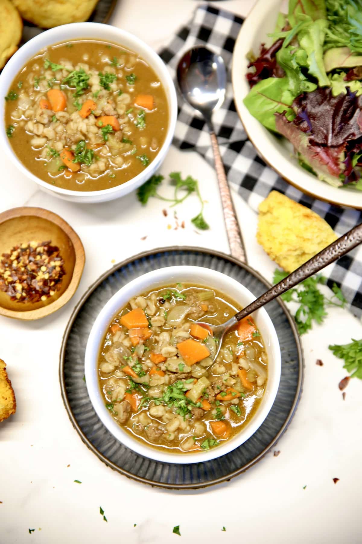 2 bowls of beef and barley soup, bowl of salad.
