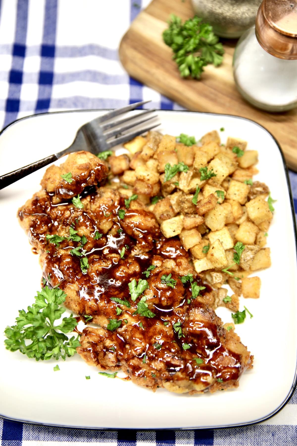 Overhead of plate with fried chicken and potatoes.