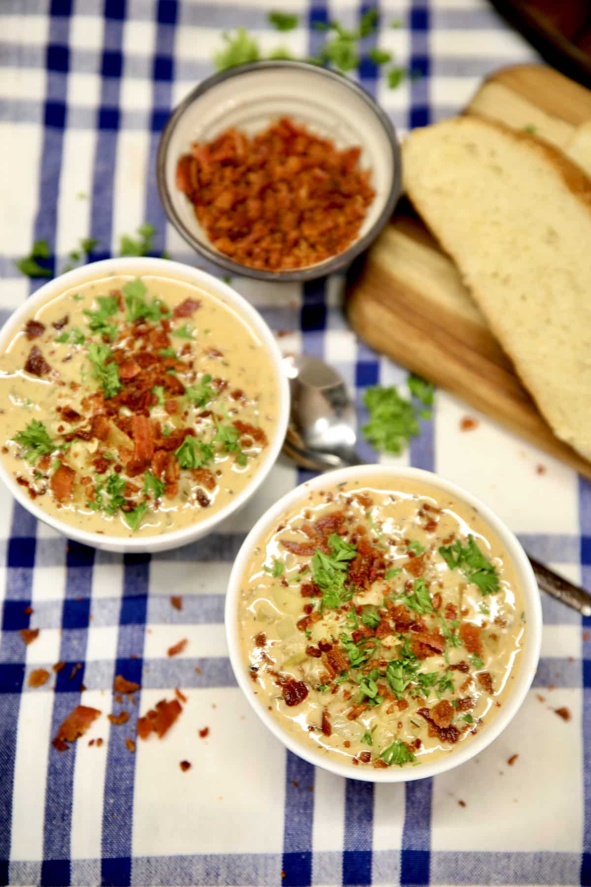 2 bowls of clam chowder, small bowl of chopped bacon.