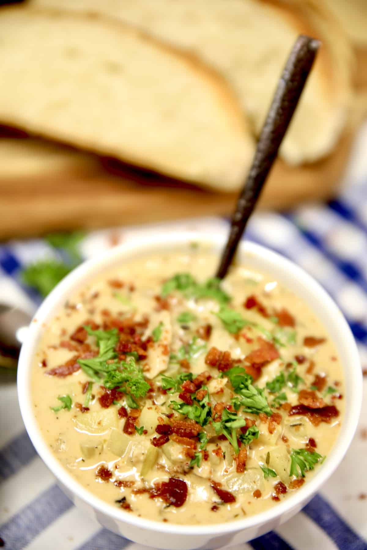 Clam chowder in a bowl with a spoon.
