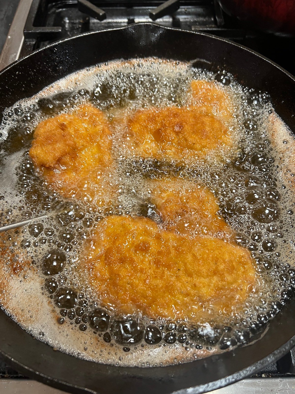 Frying pork chops in a skillet.