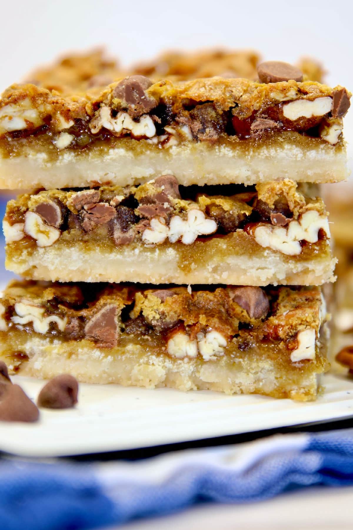 Stack of chocolate pecan pie bars.