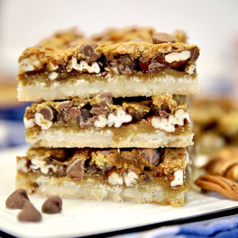 Chocolate pecan pie bars stacked.