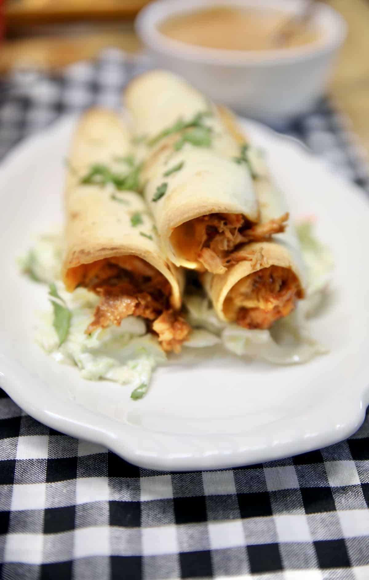 BBQ Chicken Taquitos recipe. BBQ Chicken Taquitos on a plate with coleslaw.