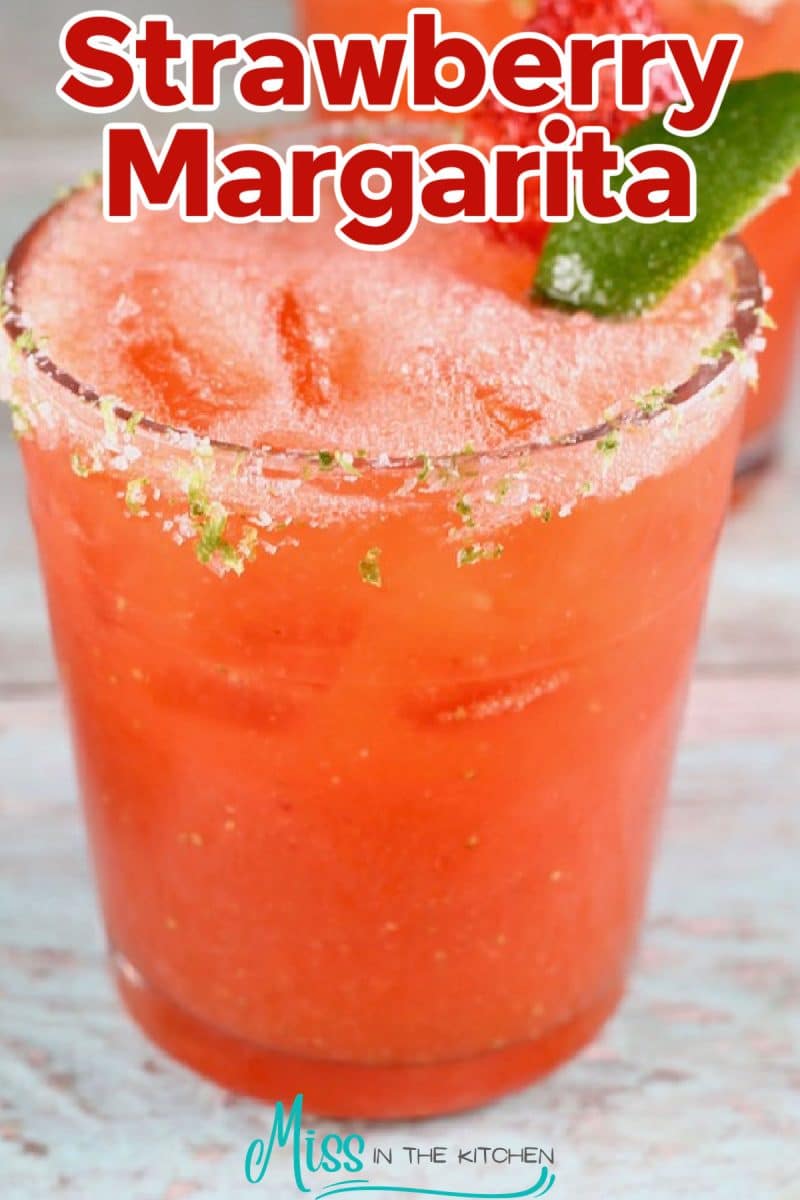Strawberry margarita with lime and strawberry garnish.
