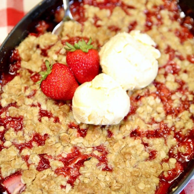 Strawberry crisp with 2 scoops of vanilla ice cream.