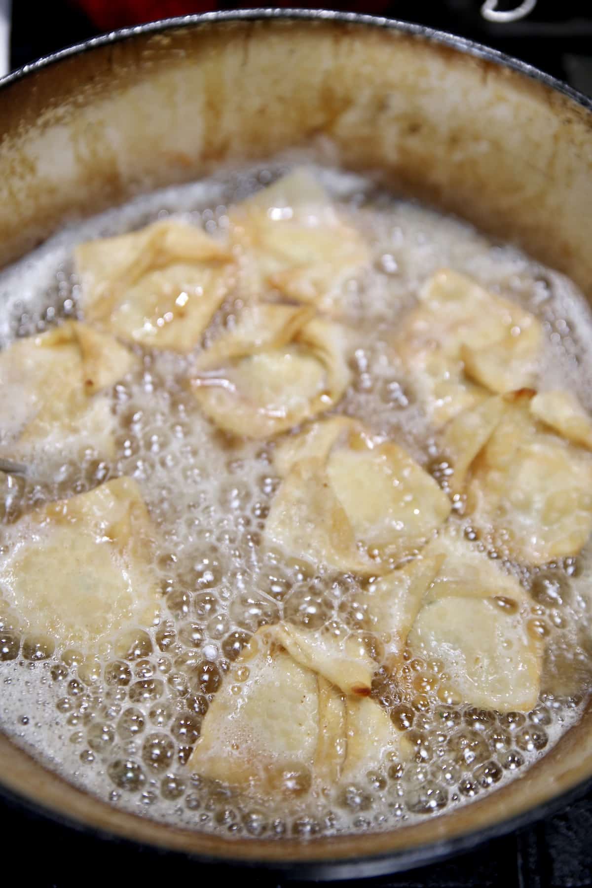 Frying shrimp rangoon.
