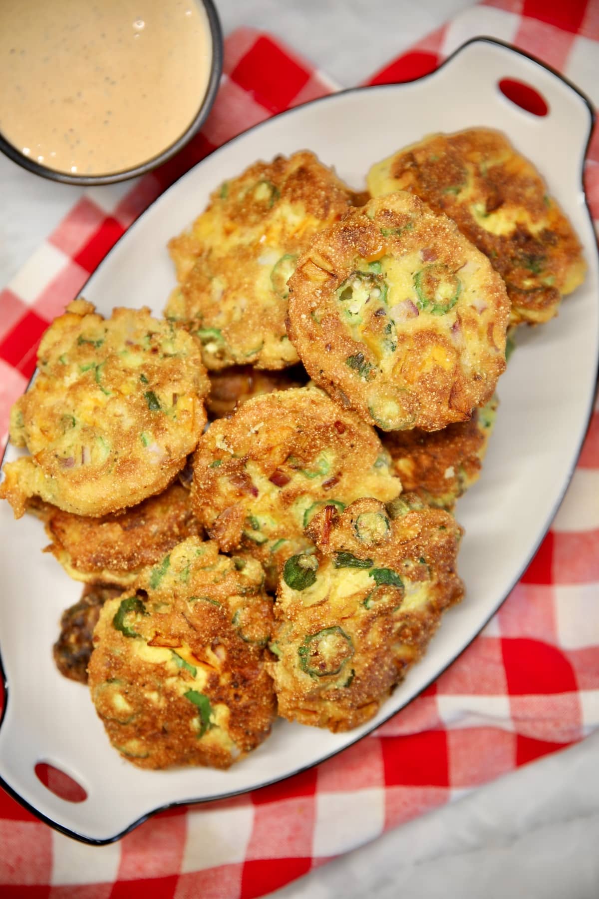 Okra patties recipe with cornmeal batter. Okra fritters on a platter.