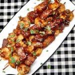 Platter of surf and turf appetizer skewers.