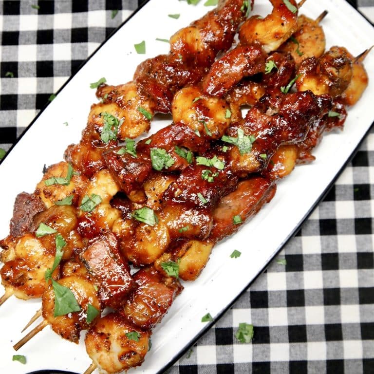 Platter of surf and turf appetizer skewers.