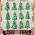 Rice krispies treats shaped liked Christmas trees on a platter.