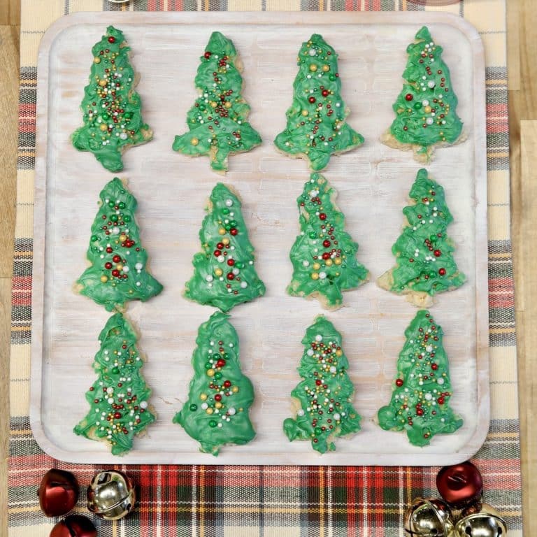 Rice krispies treats shaped liked Christmas trees on a platter.