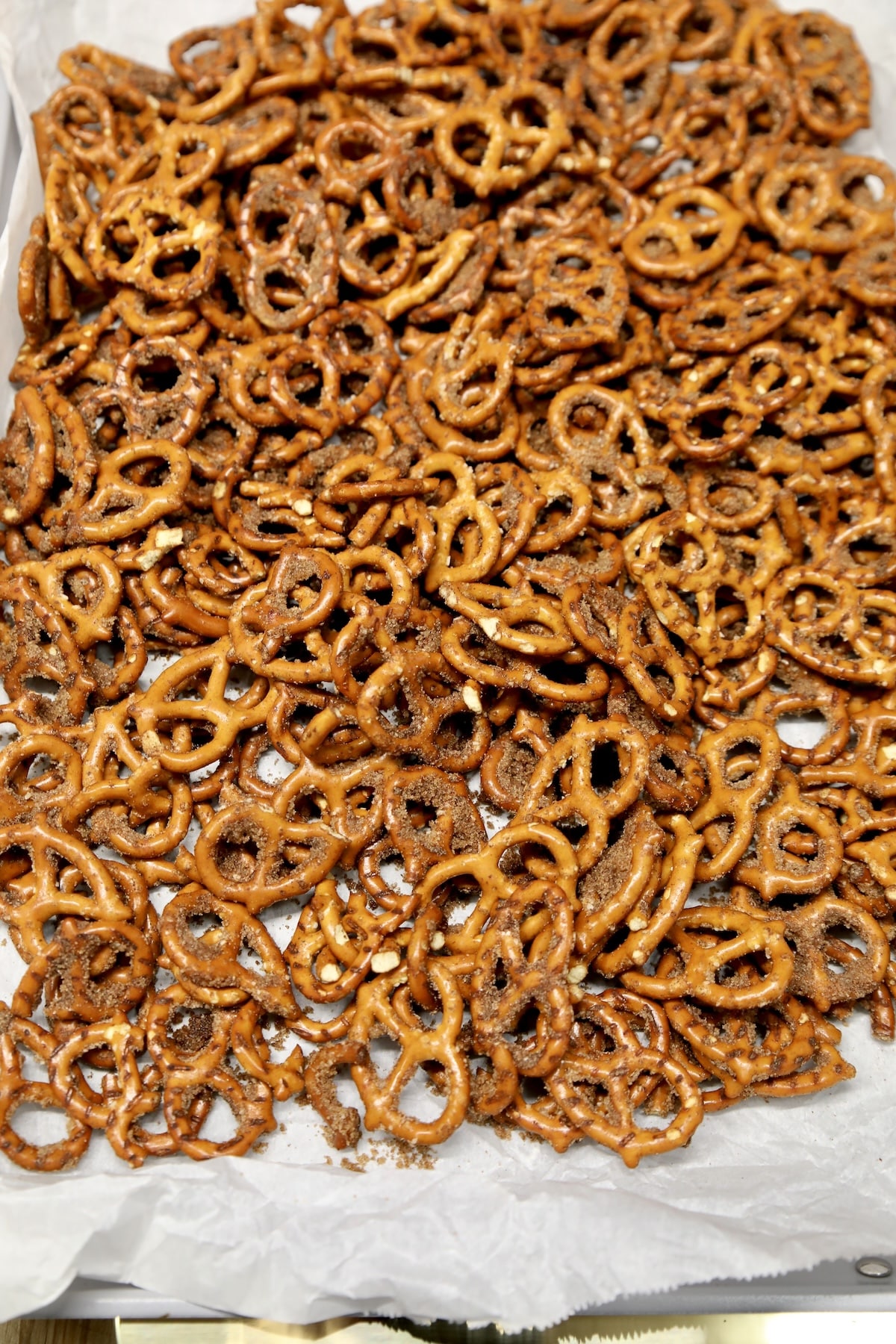 Baked pretzel twists on a parchment lined pan.