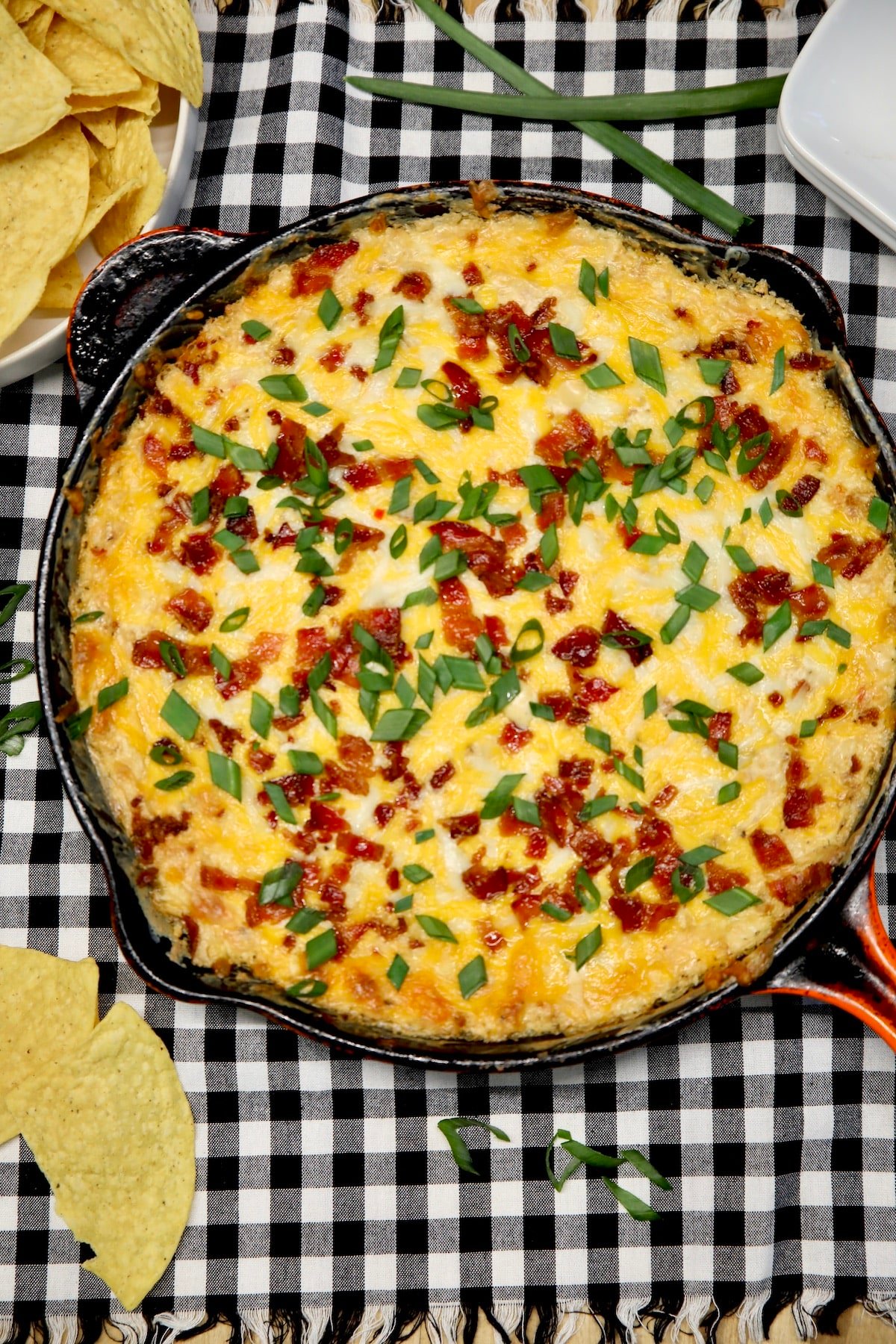 Skillet Mississippi Sin Dip Recipe. Skillet of cheesy dip with bacon and green onions.