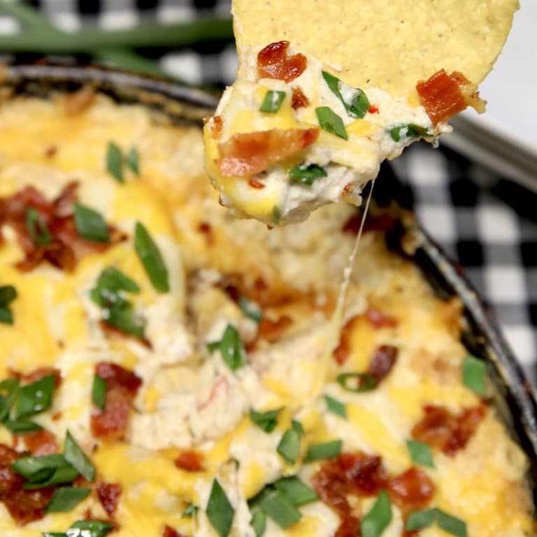 Mississippi Sin Dip in a skillet, chip dipping.