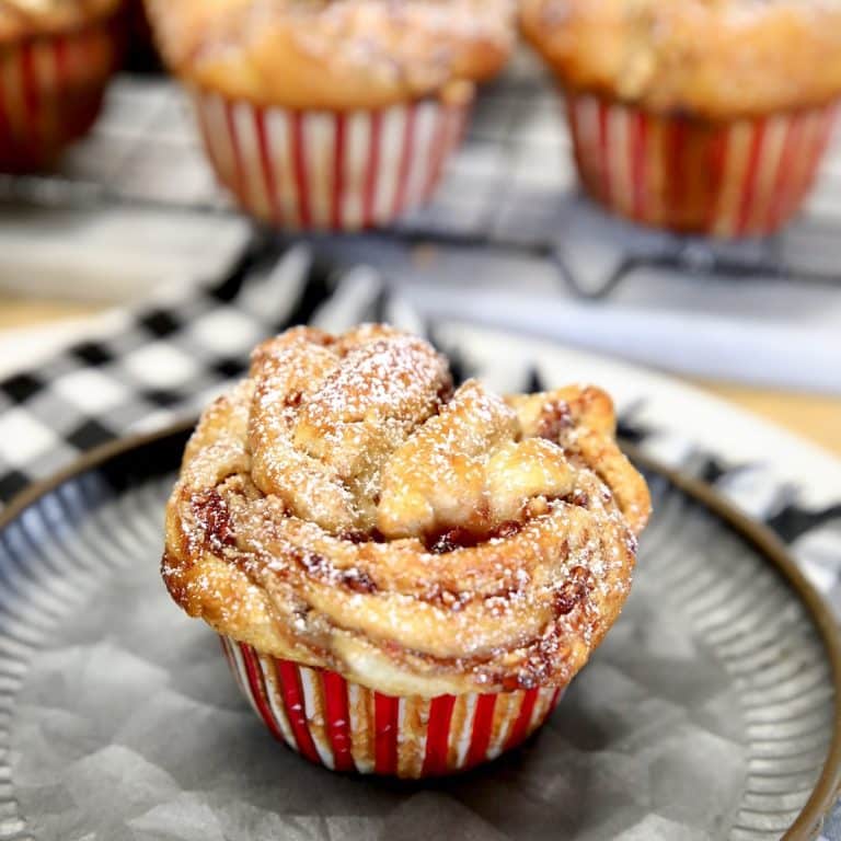 Croissant muffins with peanut butter and jam filling on a plate.