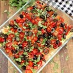 Taco dip in a casserole dish.