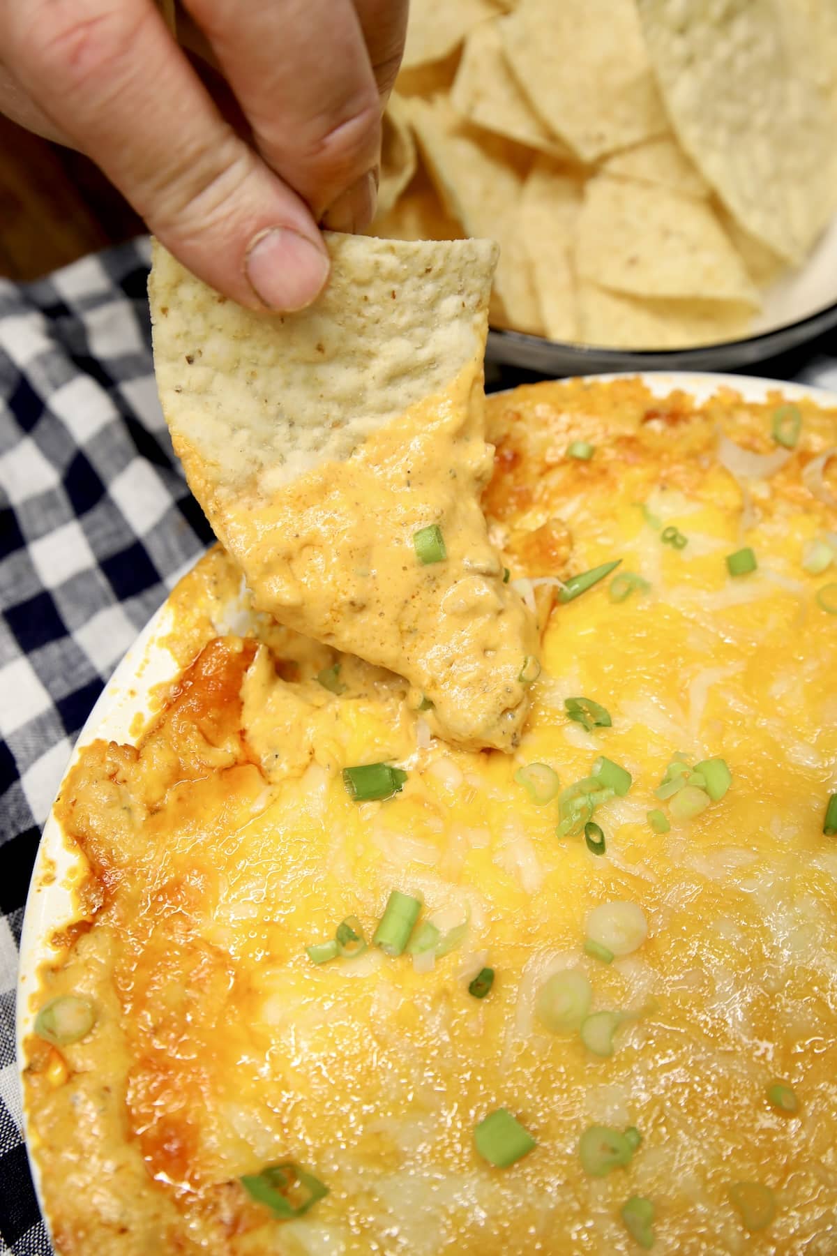 Chip dipping in buffalo chicken dip.