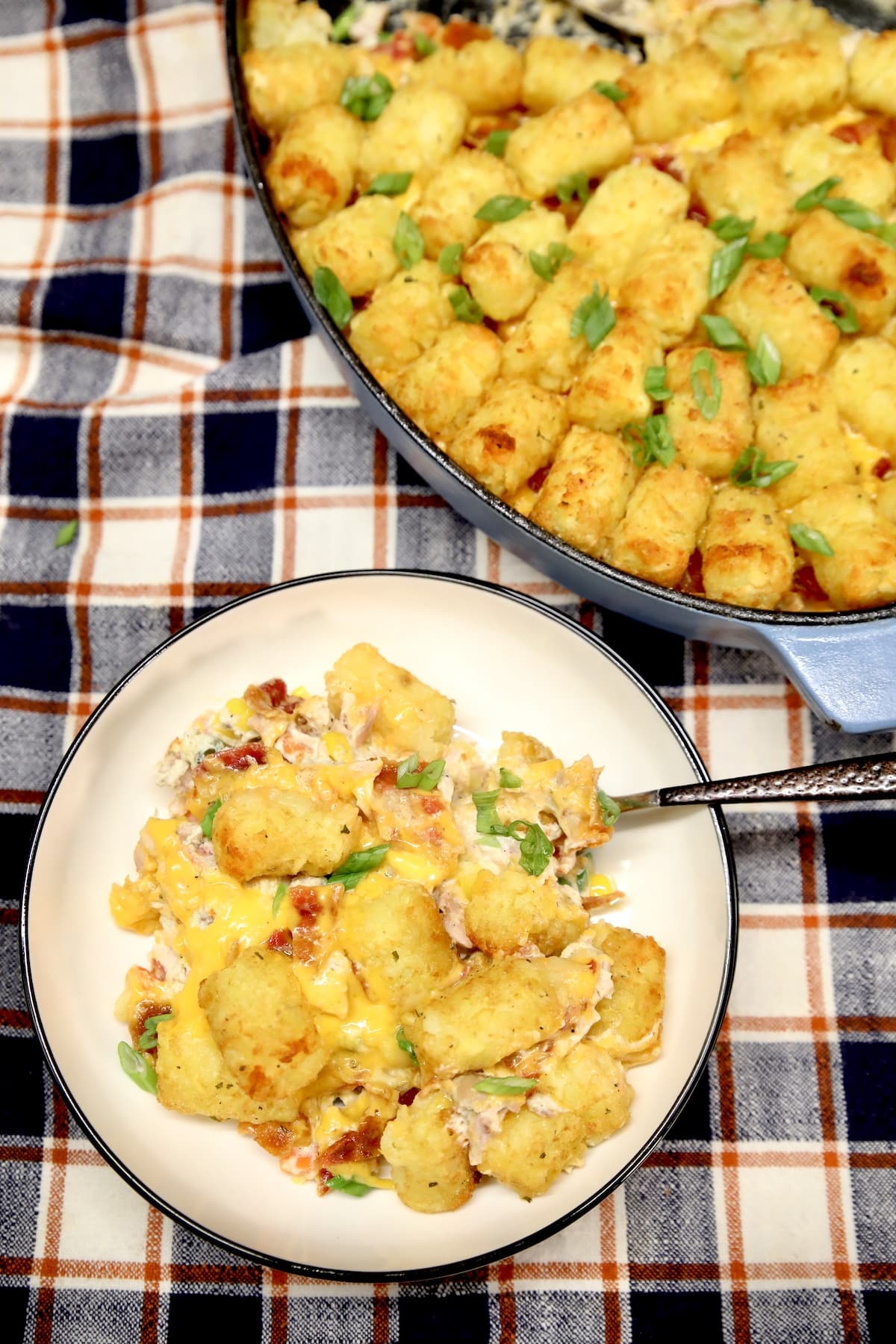 Chicken tater tot casserole on a plate - in casserole dish.