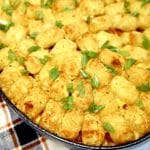 Tater tot casserole in an oval pan.