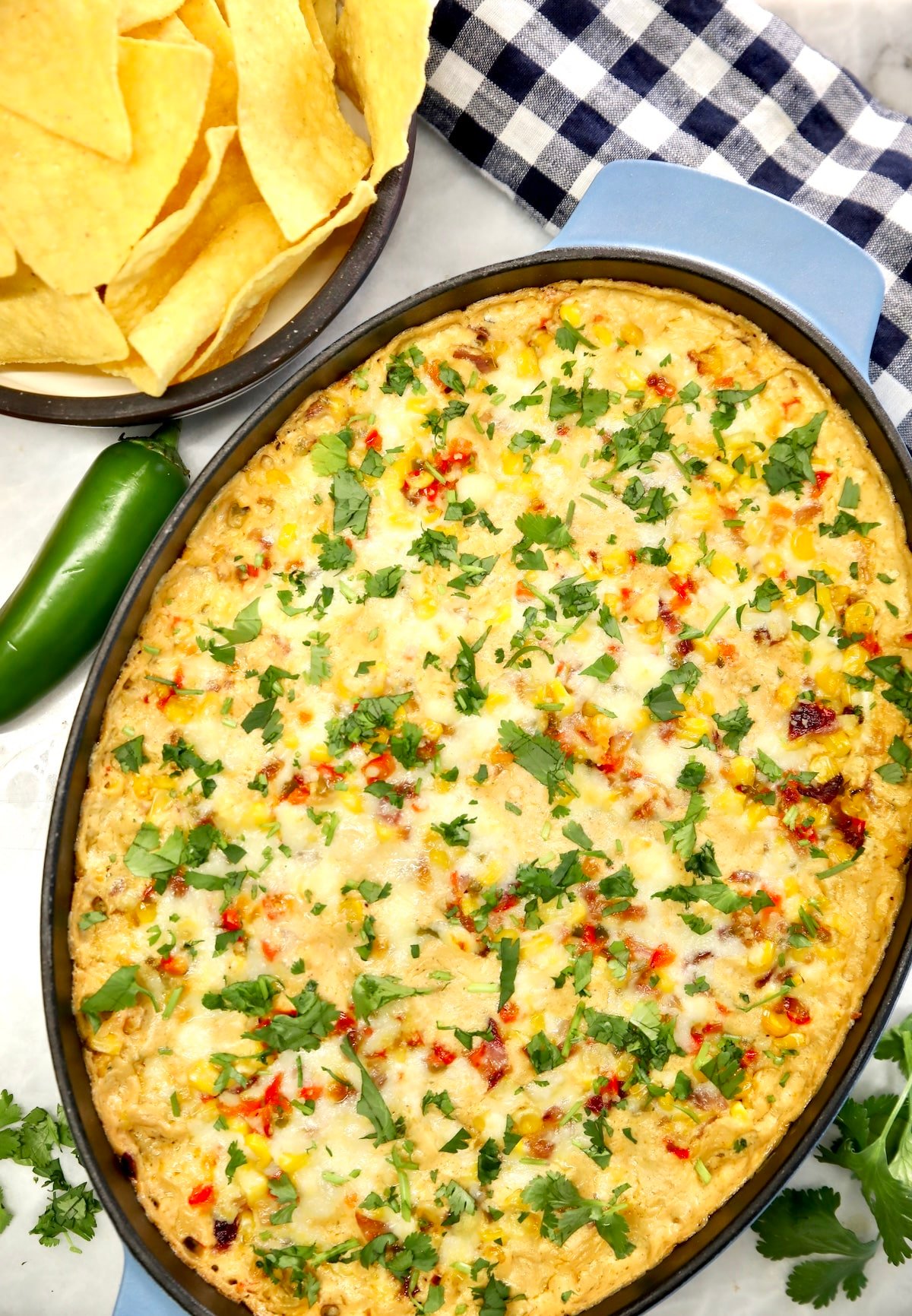 Oval casserole with baked corn dip.