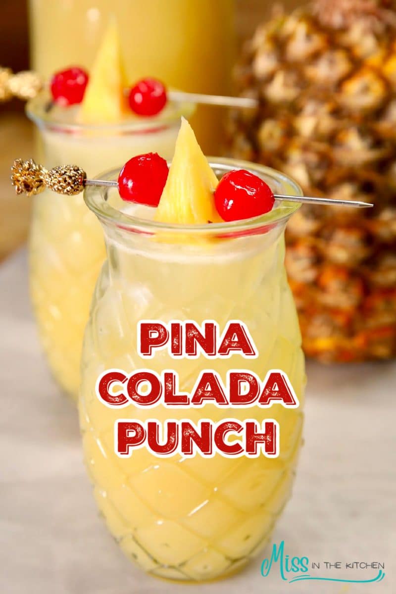 Pina Colada punch in a glass - text overlay.