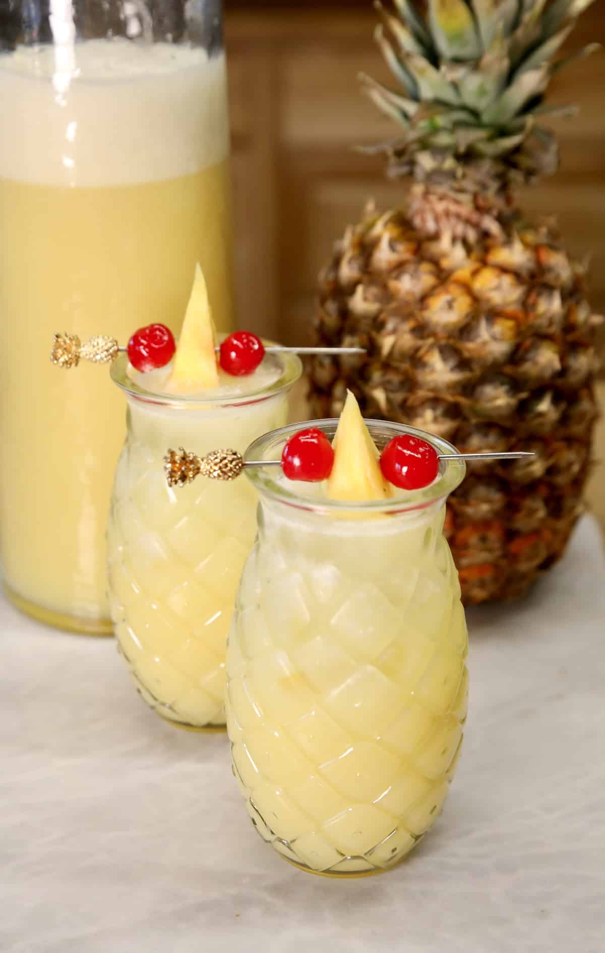2 Pineapple glasses with punch.