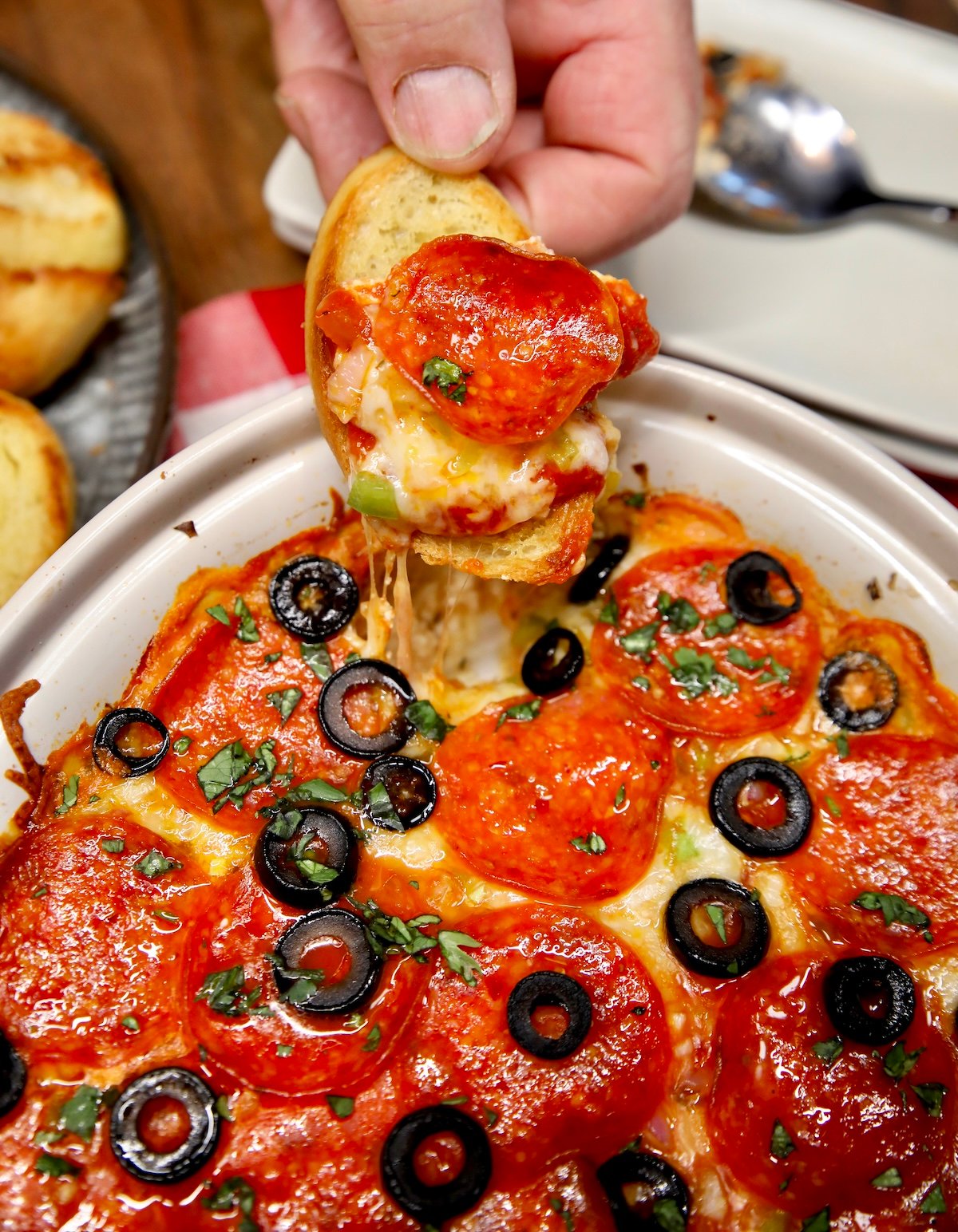 Pepperoni pizza dip on a bread slice.