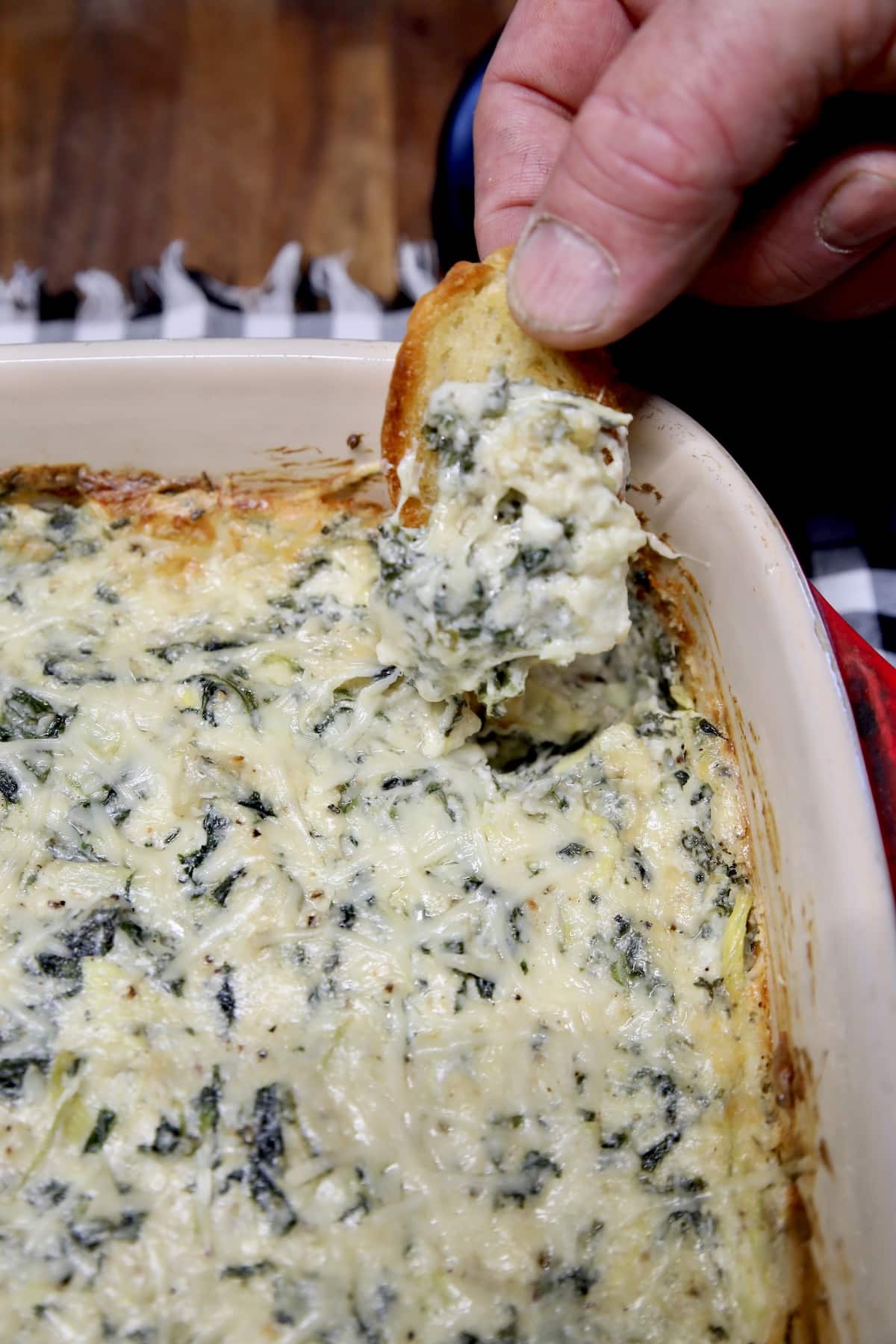 Bread dipping into creamy dip.