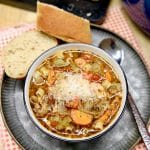 Pasta and bean soup with parmesan cheese on top.