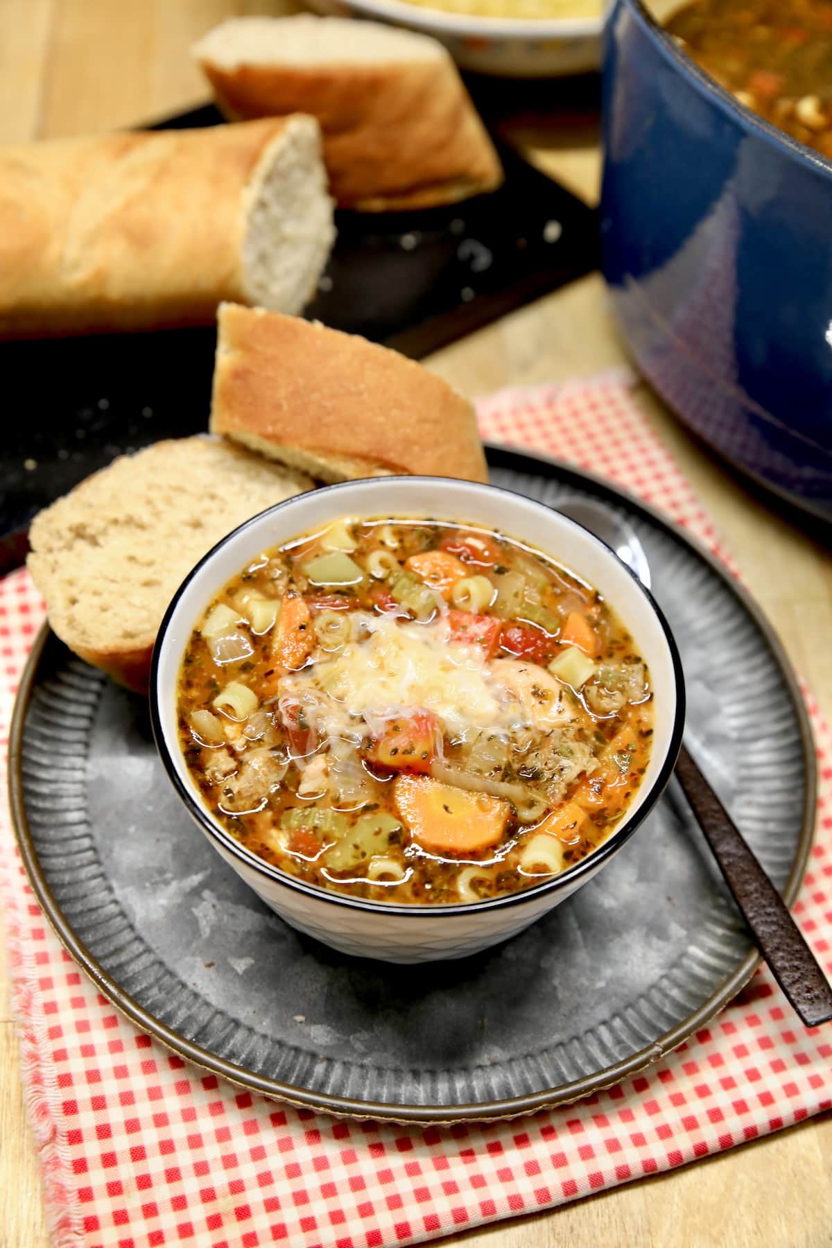 Pasta and bean soup in a bowl with parmesan.