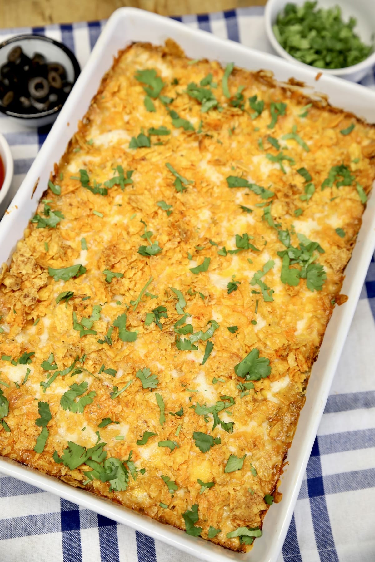 Casserole dish topped with cheese and doritos.