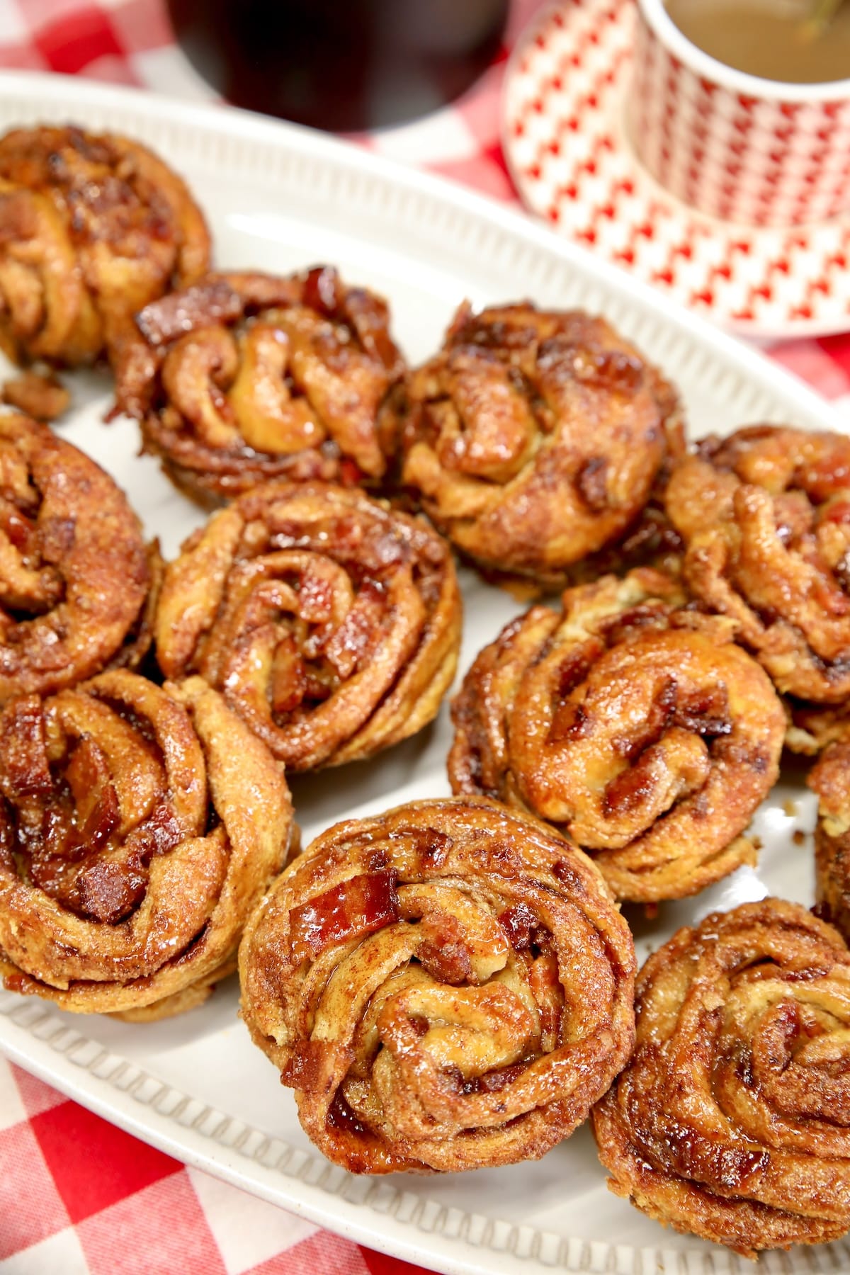 Cinnamon sugar croissant muffins with crispy bacon. Platter of bacon cruffins.