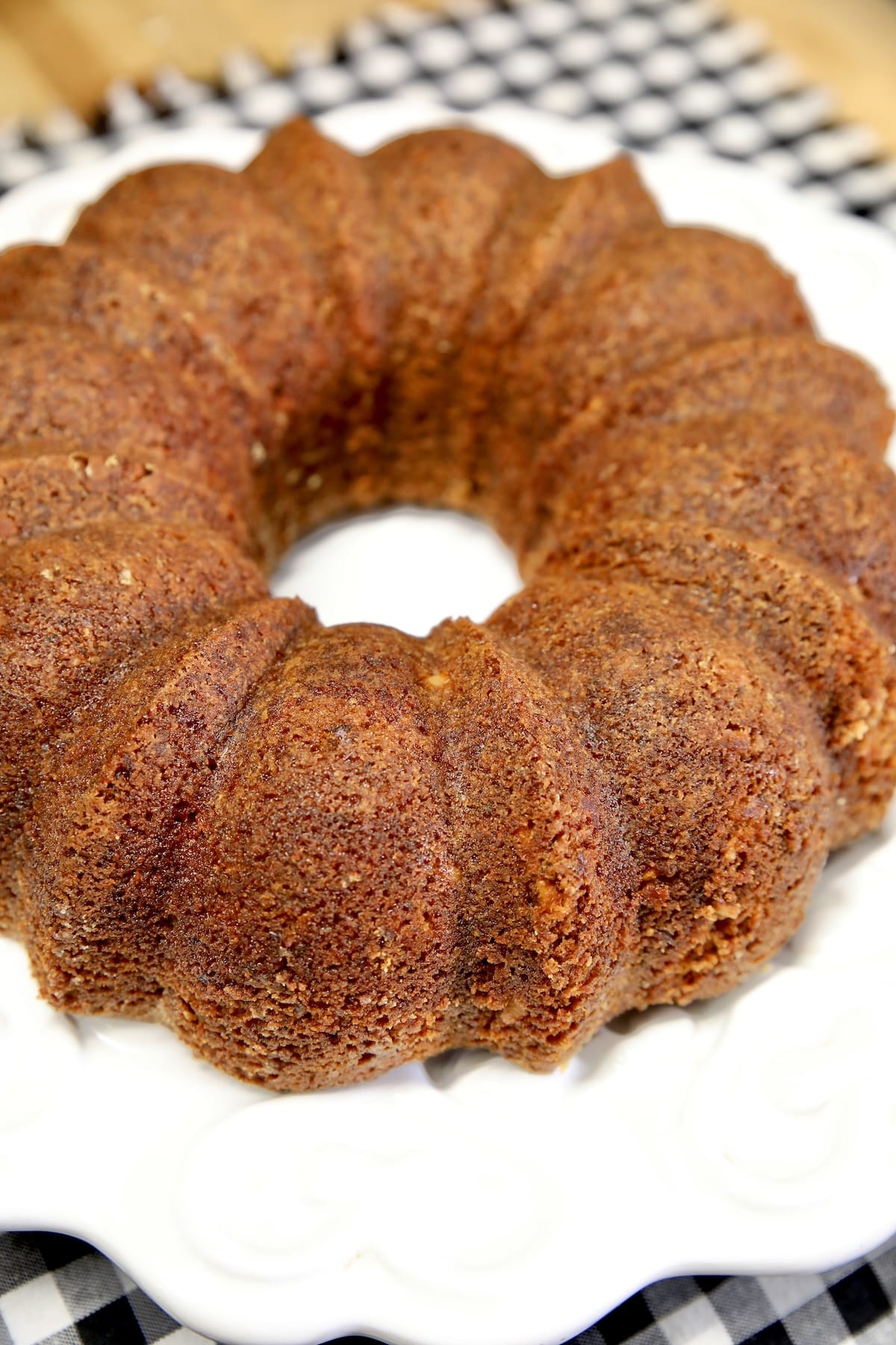 Plum baby food cake on a platter. Plum bundt cake on a white plate.