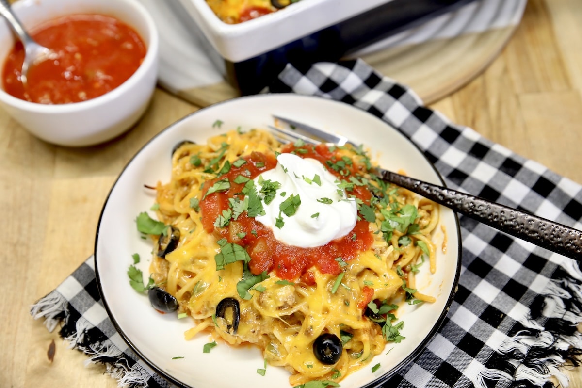Plate of Mexican spaghetti with bowl of salsa.