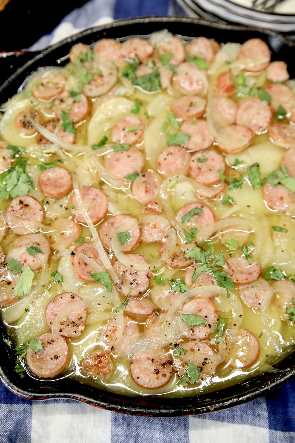 Skillet of smothered potatoes with sausage.