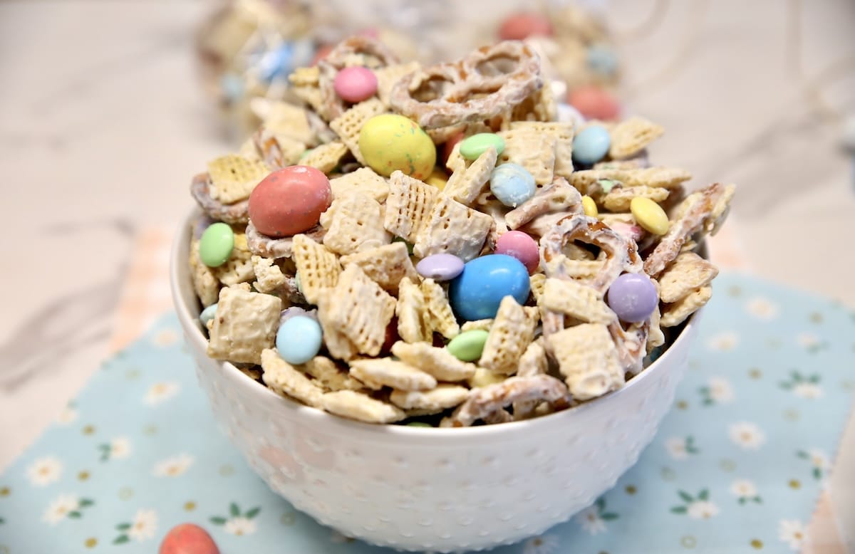 Bowl of white chocolate snack mix with Easter candy.