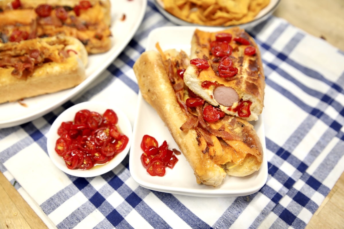 Jalapeno popper hot dogs on a platter.