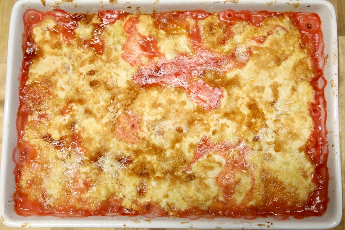 Strawberry dessert with cake mix topping in a pan.
