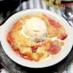 Strawberry and pineapple cake mix dessert with ice cream topping.