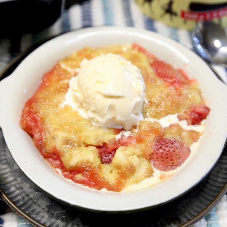 Strawberry and pineapple cake mix dessert with ice cream topping.